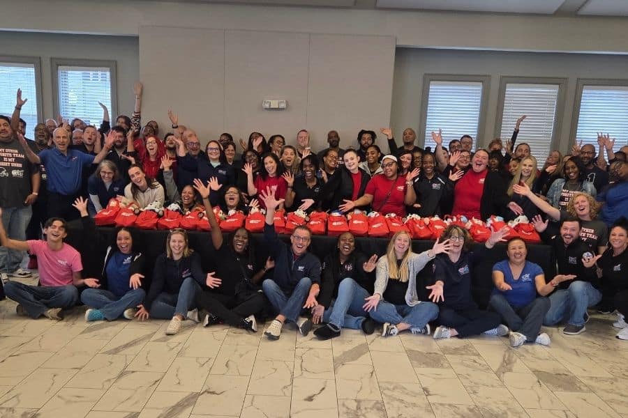 CME Federal Credit Union team with teddy bears built for the Columbus Fire Department