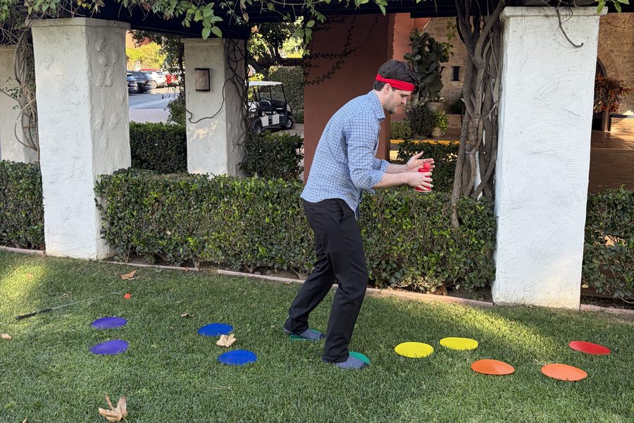 Blindfolded hotel manager listens to teammates in a Los Angeles trust game