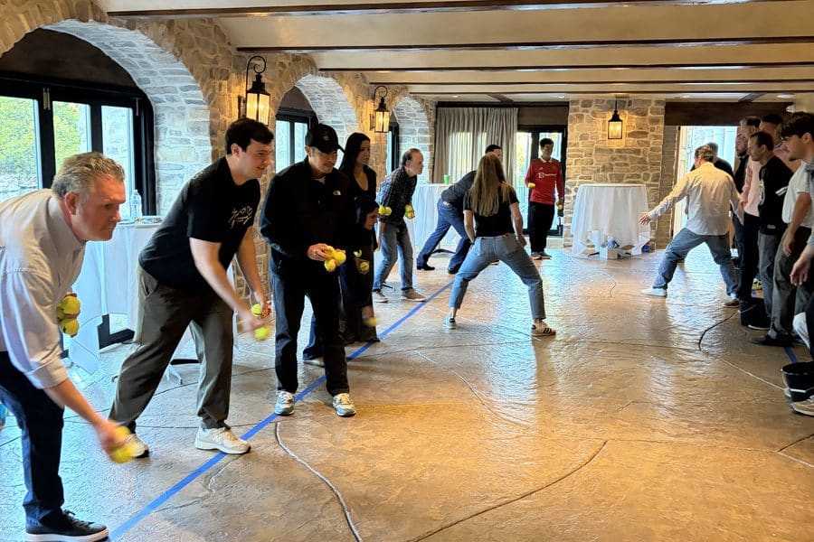 CM&B teams race to toss balls into buckets at the Westlake Village Inn