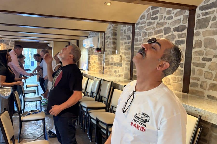 Team member balances a cookie on his face at a CM&B charity event