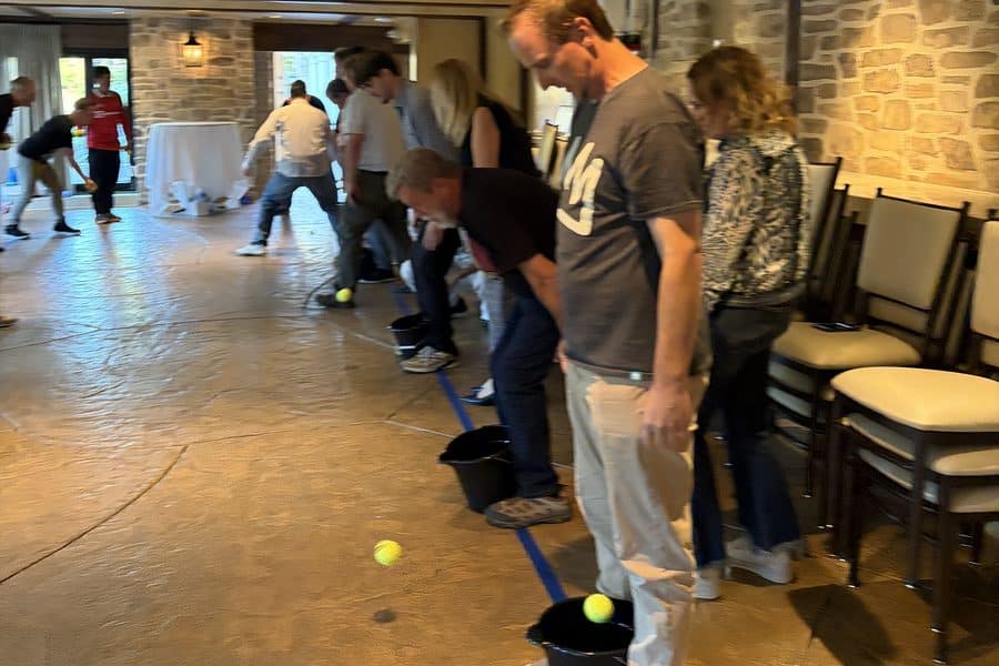 Hotel managers play a ball toss game during Hopeful Horizons in Southern California